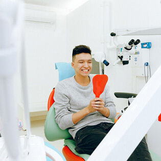 smiling man in dentist chair