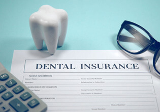 dental insurance claim form, eyeglassses, and calculator