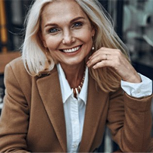 Woman smiling with dental bridge in Ware