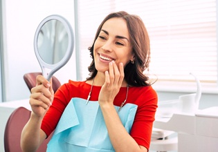 Woman smiling in the mirror in red shirt