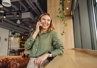 Woman smiling while talking on phone
