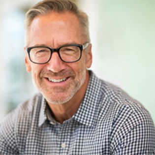 smiling man with dental bridge in ware