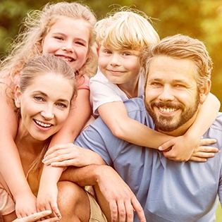 Smiling family of three outdoors