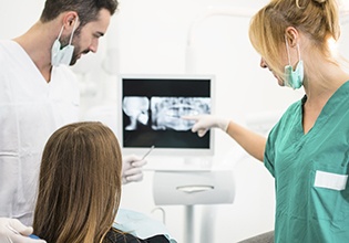 Dentist and patient looking at x-rays