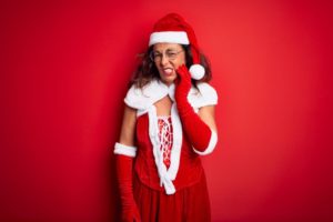 woman in Santa suit with toothache
